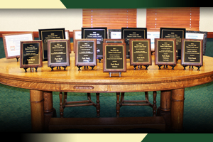 Table with plaques commemorating awards Park Bank has received